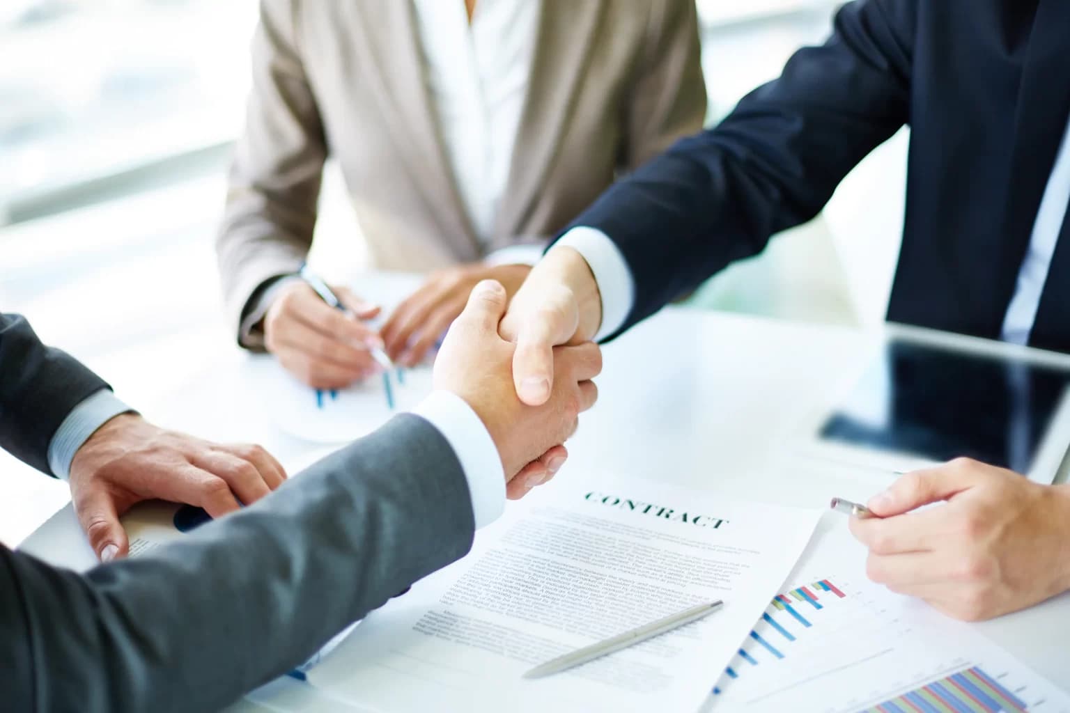 Corporate business executives shaking hands on commercial agreement for Tender Bidding Support Service