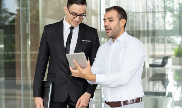 Technology and IT business consultants discussing software and setup for PRO & Documentation Services Offered by Plus UAE - Abu Dhabi (Documentation Services in Abu Dhabi)