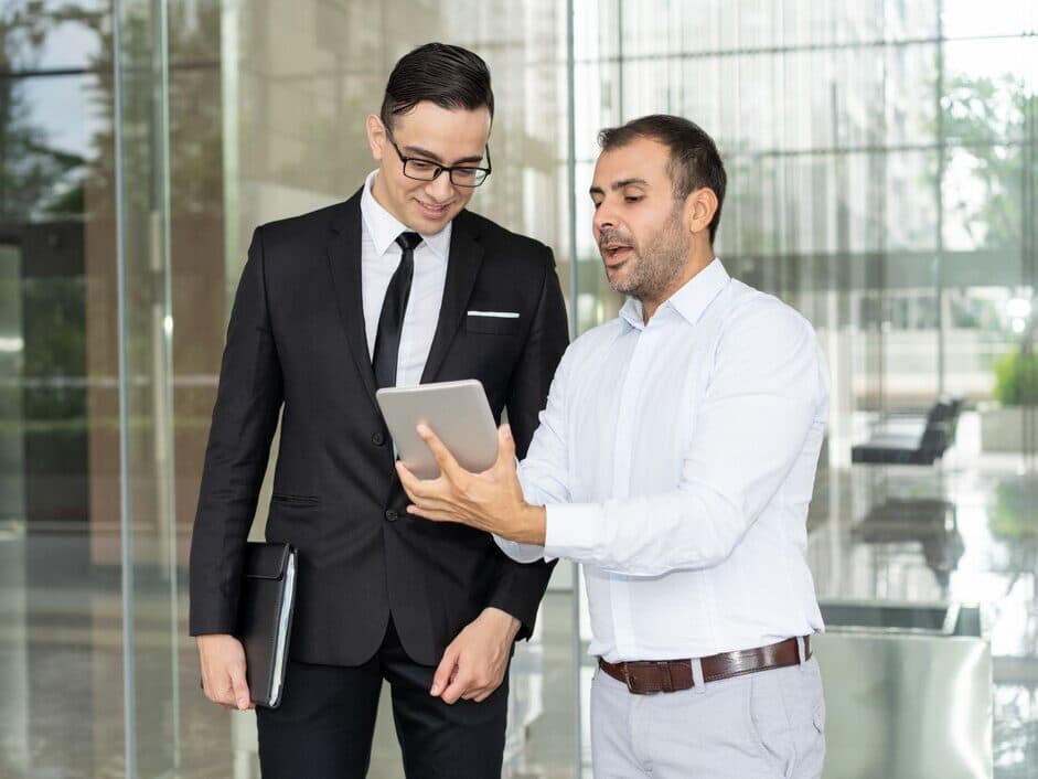 Technology and IT business consultants discussing software and setup for Business Management Consulting Services in UAE